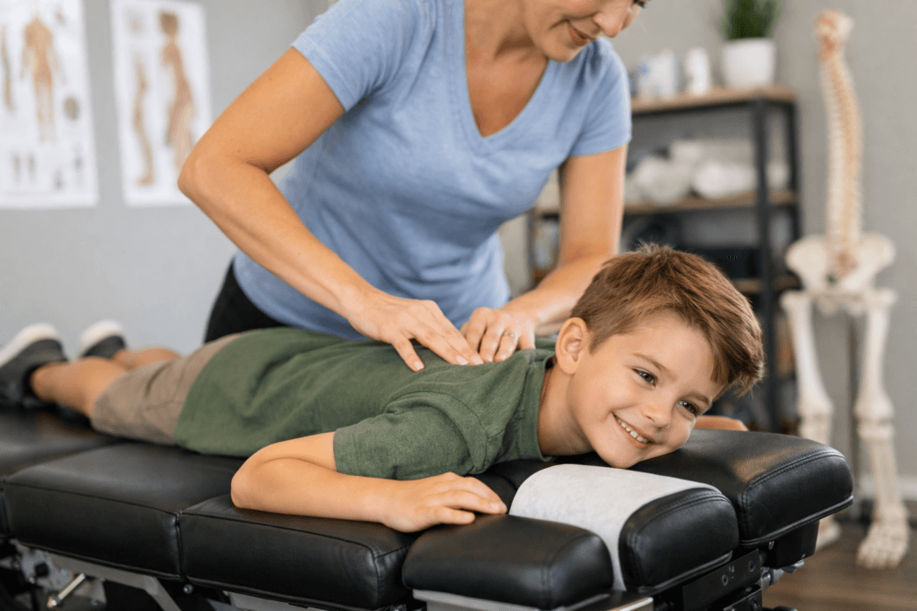 Kids chiropractor in Langley performing gentle chiropractic adjustment on a child in a modern clinic treatment room